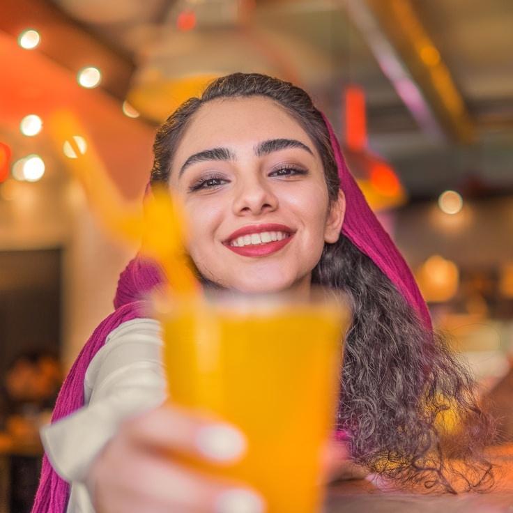 Kaveri Mehta, Lead Design Curator at Coast Lunar Cottage, reviewing corporate floral arrangements